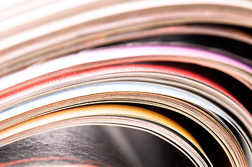 Image showing Stack of open magazines