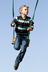 Image showing Happy child on a swing