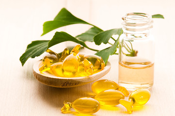 Image showing ginko biloba essential oil with fresh leaves - beauty treatment