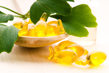 Image showing ginko biloba essential oil with fresh leaves - beauty treatment