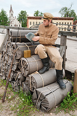 Image showing Retro style picture with soldier sitting on the bundles