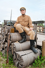 Image showing Retro style picture with soldier sitting on the bundles