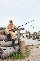 Image showing Retro style picture with soldier sitting on the bundles