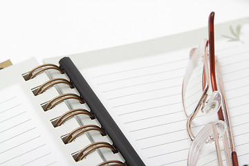 Image showing Glasses and a pencil on a diary