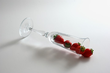 Image showing Strawberries spilled from wineglass