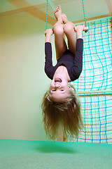 Image showing child at her home sports gym swinging