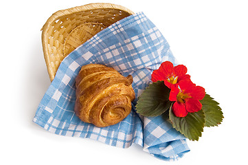 Image showing Croissant with a basket and flowers
