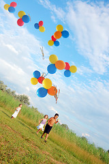 Image showing children running with balloons