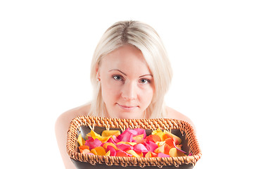 Image showing Woman and petals on the plate