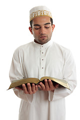 Image showing Man reading a religious or other book