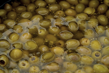 Image showing Green pitted olives in oil