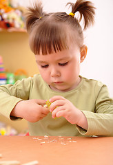 Image showing Little girl sharpening a pencil