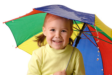 Image showing Cute child catching raindrops under umbrella