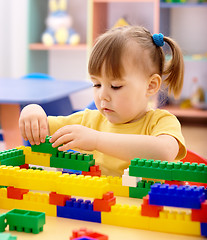 Image showing Little girl play with building bricks in preschool