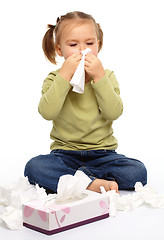 Image showing Little girl blows her nose