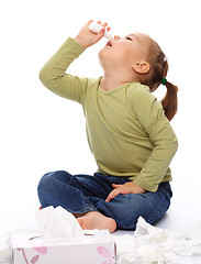 Image showing Little girl spraying her nose