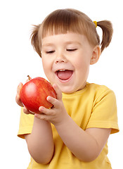 Image showing Cute child is going to bite an apple