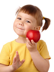 Image showing Cute child is going to bite an apple