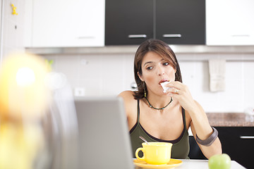 Image showing Modern woman reading e-mails at her breakfast