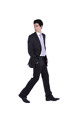 Image showing Businessman walking and looking back