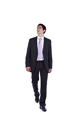 Image showing Businessman walking and looking up