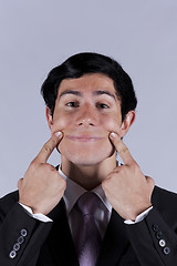 Image showing Young businessman with a funny face