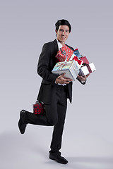 Image showing Businessman with many gift packages
