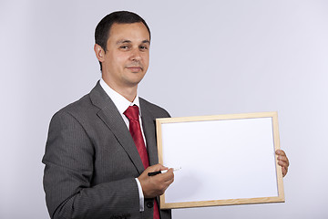 Image showing businessman holding a whiteboard