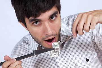 Image showing Man eating little dollar banknote