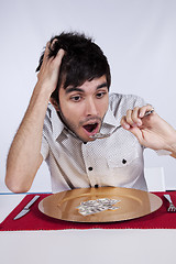 Image showing Man eating little dollar banknote