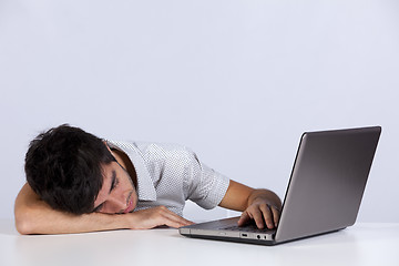 Image showing Exhausted man sleeping at his office