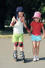 Image showing Friendly support. Rollerblading.