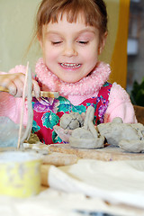 Image showing child playing with clay