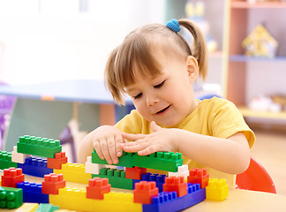 Image showing Little girl play with building bricks in preschool