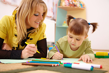 Image showing Teacher with child in preschool