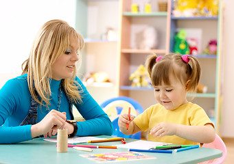 Image showing Teacher with child in preschool