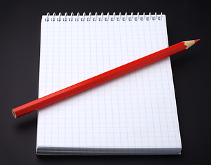 Image showing Blank notepad and a pencil on black