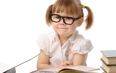 Image showing Happy little girl with book wearing black glasses