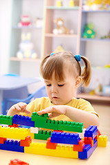 Image showing Little girl play with building bricks in preschool