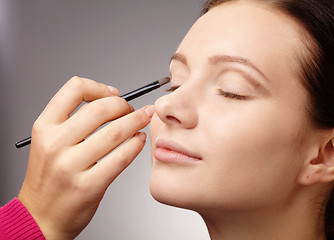 Image showing Applying eyeshadow for young girl