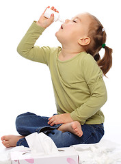 Image showing Little girl spraying her nose