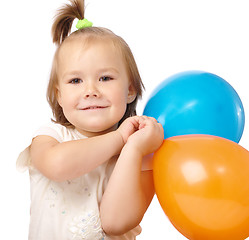 Image showing Cute little girl with two colored balloons