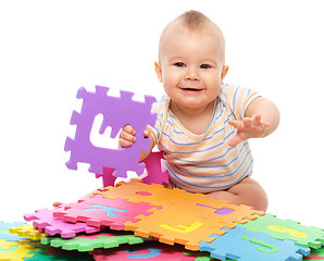 Image showing Little boy plays with alphabet