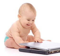 Image showing Little baby with laptop