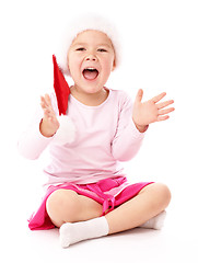 Image showing Little girl wearing red Christmas cap