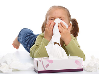 Image showing Little girl blows her nose