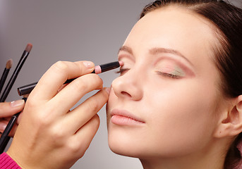 Image showing Applying eyeshadow for young girl