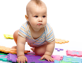 Image showing Little boy plays with alphabet