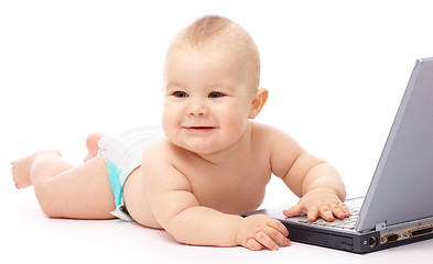 Image showing Little baby with laptop