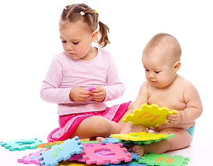 Image showing Little boy and girl are playing with alphabet